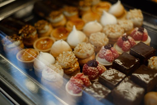 Vitrine de desserts variés avec feuilletés pralinés, mousses au chocolat et petits gâteaux décorés.